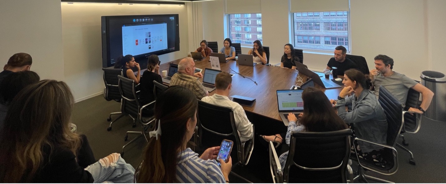 Pic of the group working together looking at a big screen