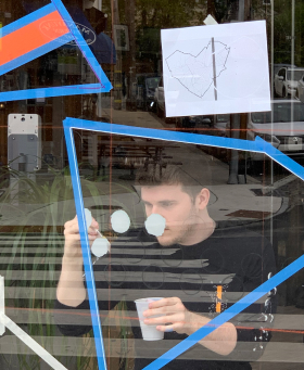 person painting a window