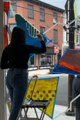 person painting window